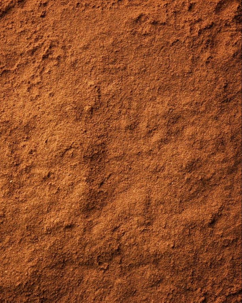 A close-up image of ground cinnamon spice.